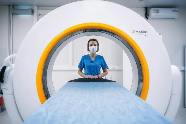 a woman is sitting in a mri machine, a picture, by Adam Marczyński, cyan and orange, sitting on a lab table, medical equipment, möbius