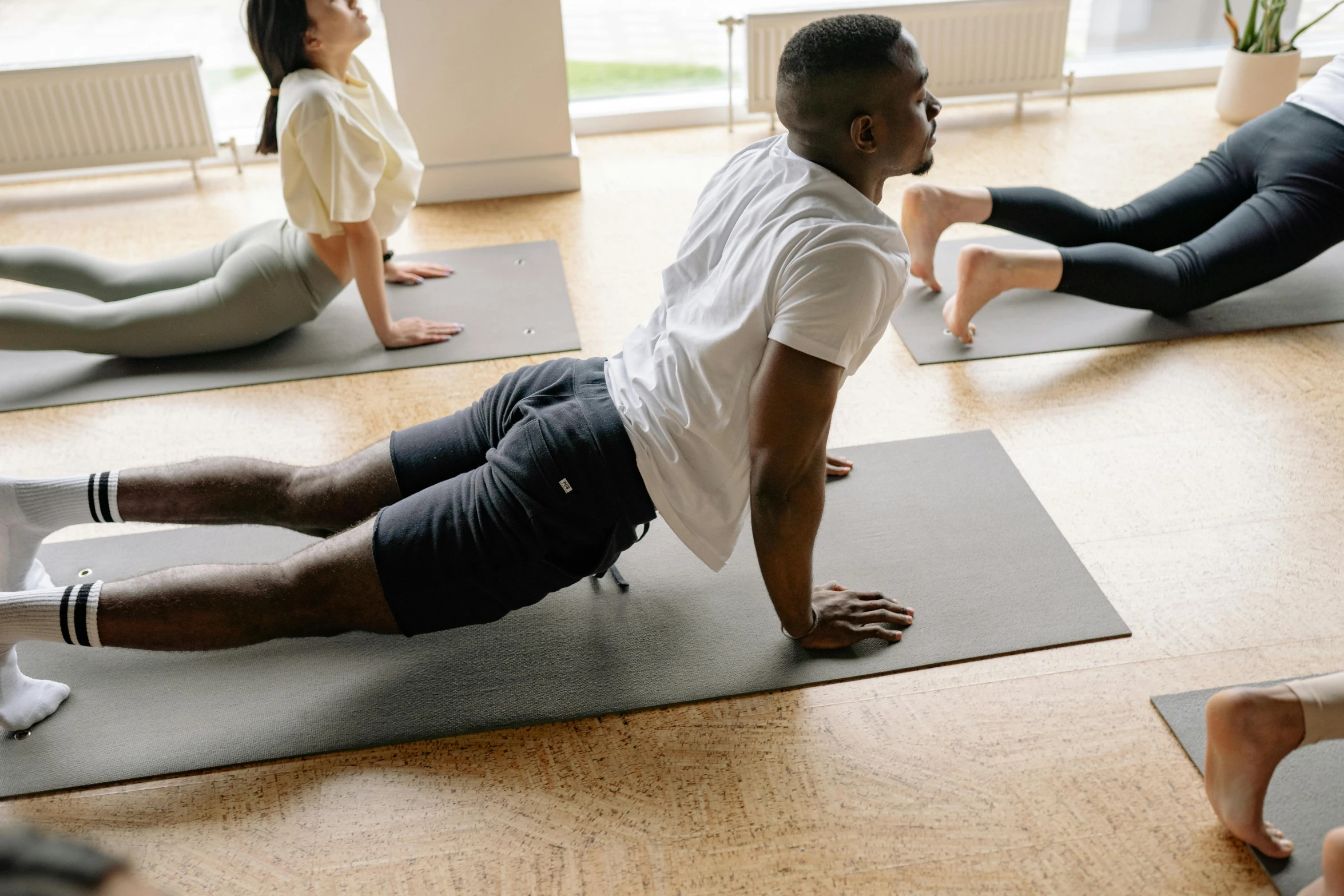 several people are doing yoga in a room