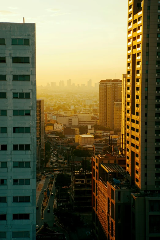 a view of a city from a high rise building, inspired by Elsa Bleda, pexels contest winner, minimalism, philippines, golden hues, 8k resolution”, multiple stories