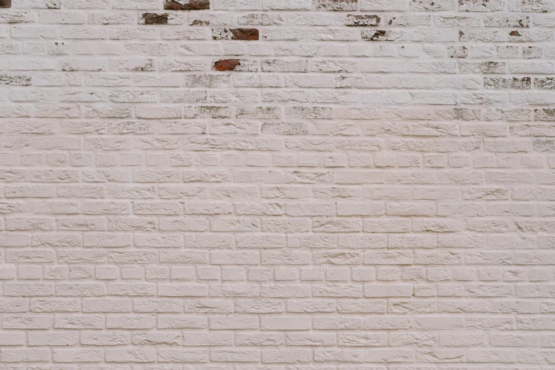 a brick wall with a clock mounted on it