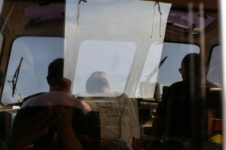 a group of people sitting in a boat looking out the windows