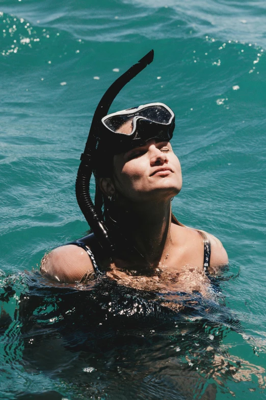 woman in the water wearing diving goggles and swimming masks