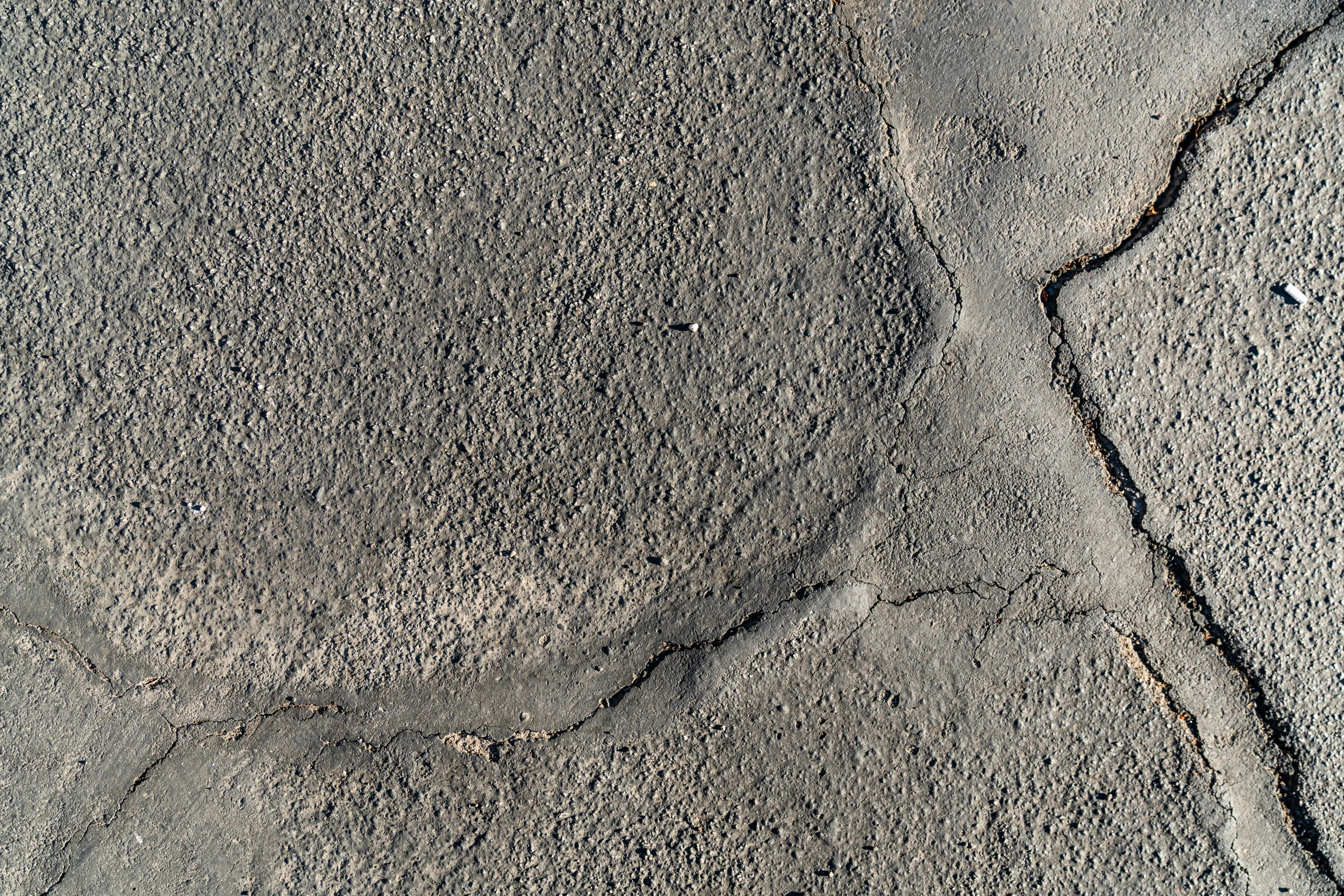 a red fire hydrant sitting on the side of a road, an album cover, inspired by Lucio Fontana, reddit, concrete art, 4 k seamless mud texture, on the surface of the moon, ignant, detailed product image