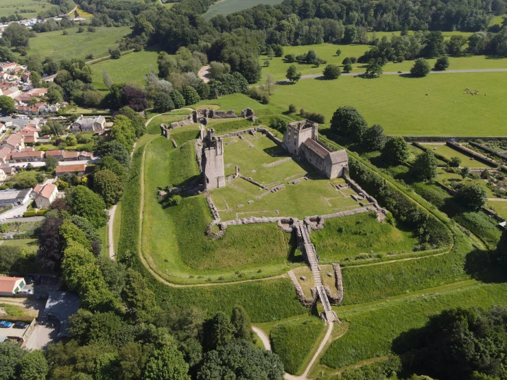 an old castle has some grass in the front of it