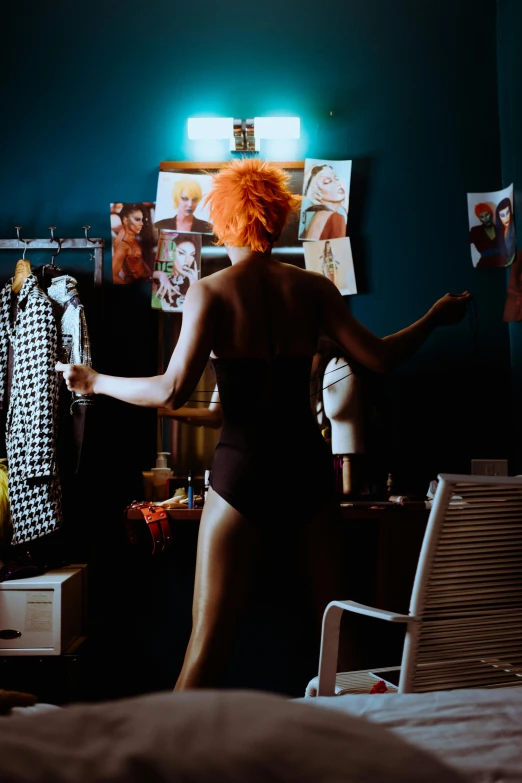 a woman in her underwear and an orange wig standing in her bedroom