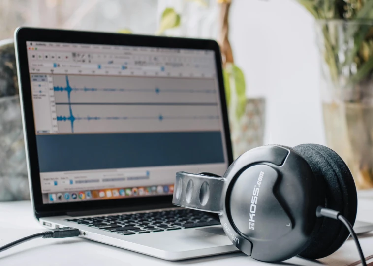 a laptop computer sitting on top of a desk next to a pair of headphones, trending on pexels, analytical art, sitting in front of a microphone, arcs, uncropped, gorecore