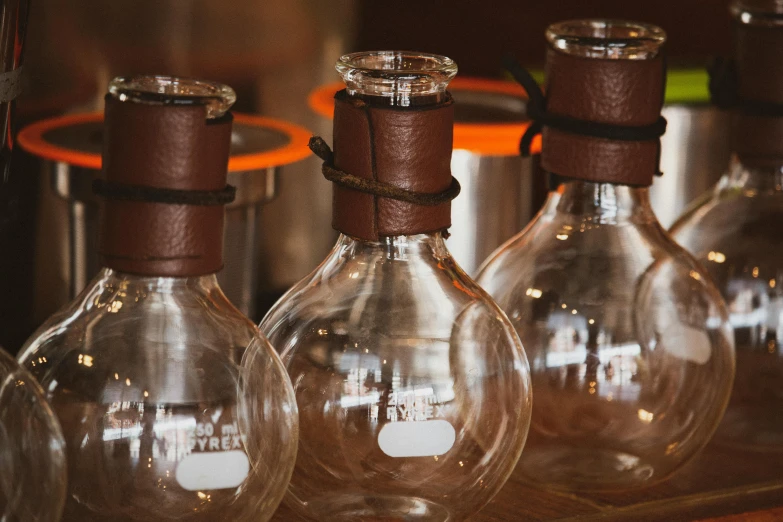 a group of glass filled vases on top of a table