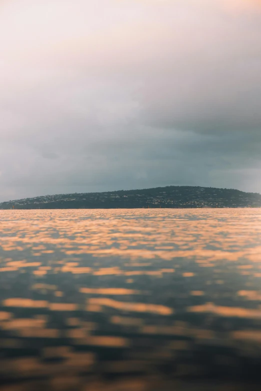 the sunset reflects on calm water in an ocean