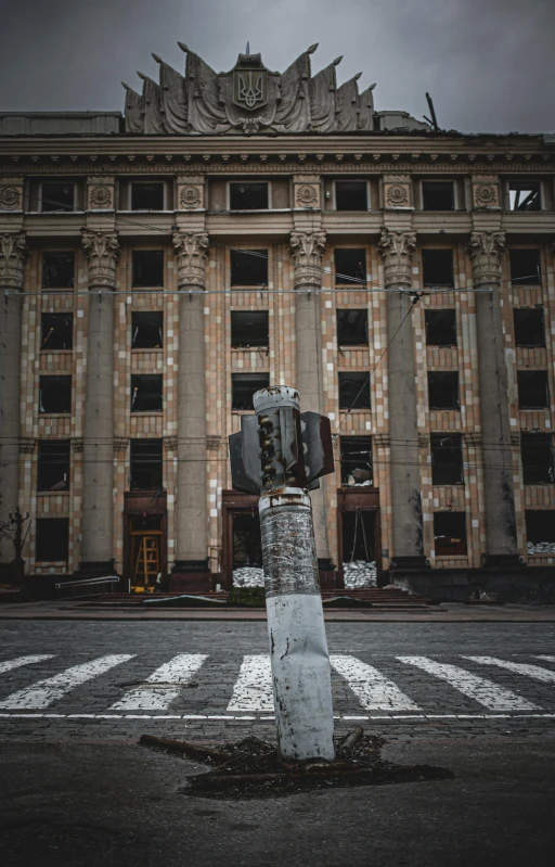 a traffic light sitting on the side of a road, a statue, by Andrew Stevovich, pexels contest winner, socialist realism, post apocalyptic building, ukrainian, low quality photo, with stalinist style highrise