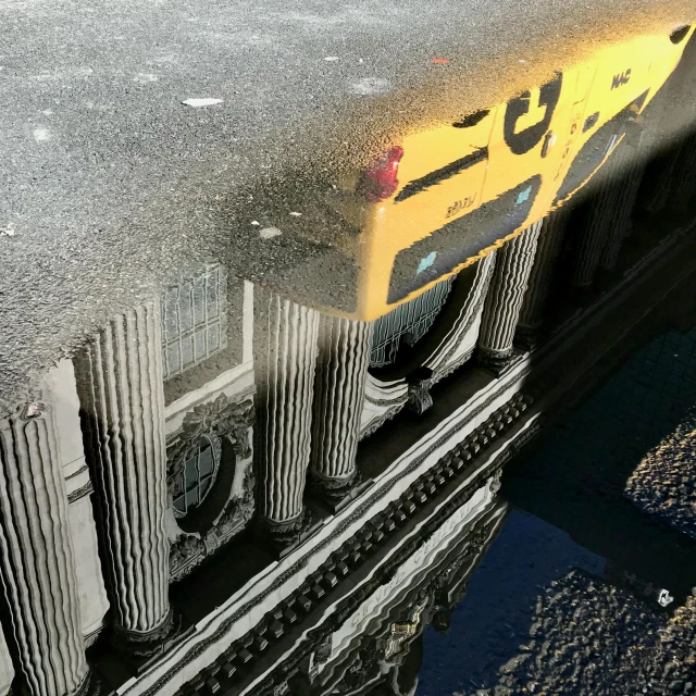 a school bus reflected in a puddle of water, a detailed matte painting, inspired by Hubert Robert, neo classical architecture, yellow and black trim, camera looking down upon, photo from a spectator