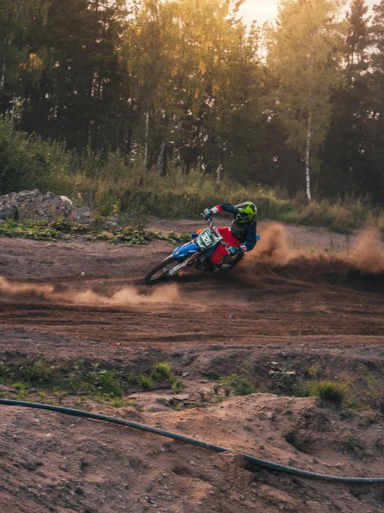 a person riding a dirt bike on a dirt track, pexels contest winner, avatar image, red and blue back light, low quality photo, schools