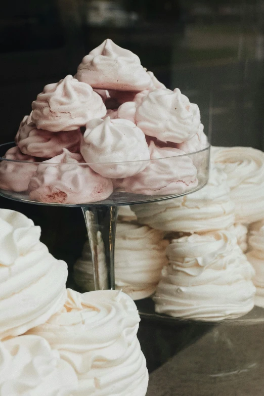 a display case filled with lots of white and pink meringue, a still life, by Matija Jama, trending on unsplash, made of glazed, stacked, vintage soft grainy, promo image