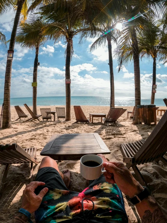 a man relaxing in a hammock at the beach