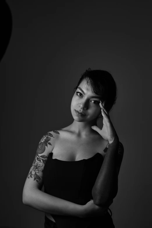 a black and white photo of a woman with tattoos, inspired by irakli nadar, pexels contest winner, in a photo studio, various posed, icon black and white, an asian woman