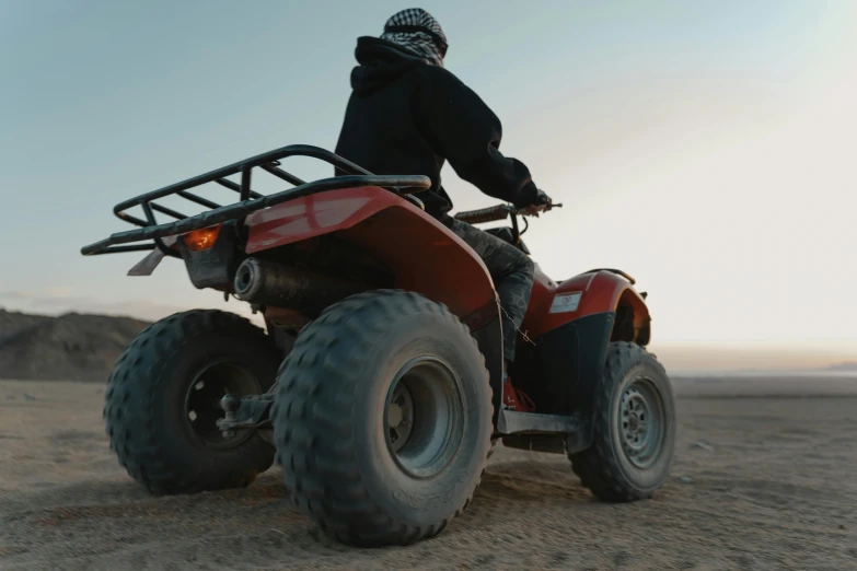 man on four wheeler in desert at dusk