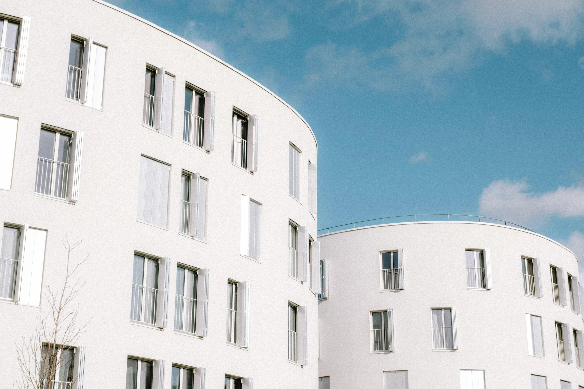 a building with white windows sitting on a street