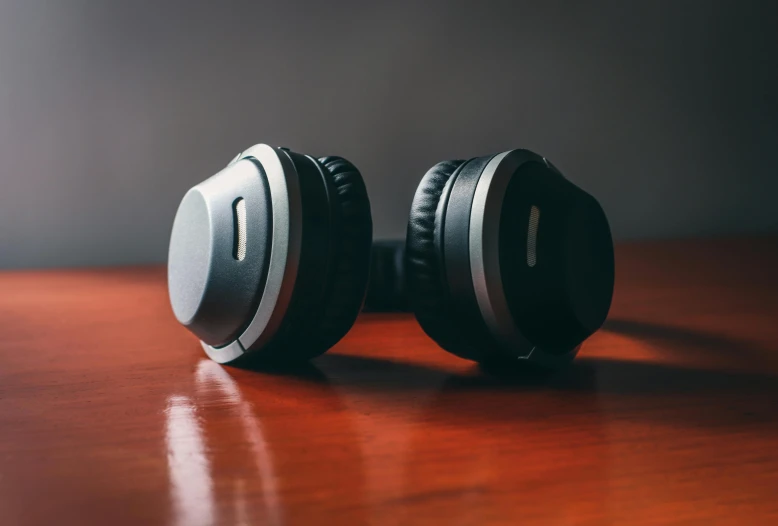 a pair of headphones sitting on top of a wooden table, trending on pexels, avatar image, grey ears, sleek spines, voluminous