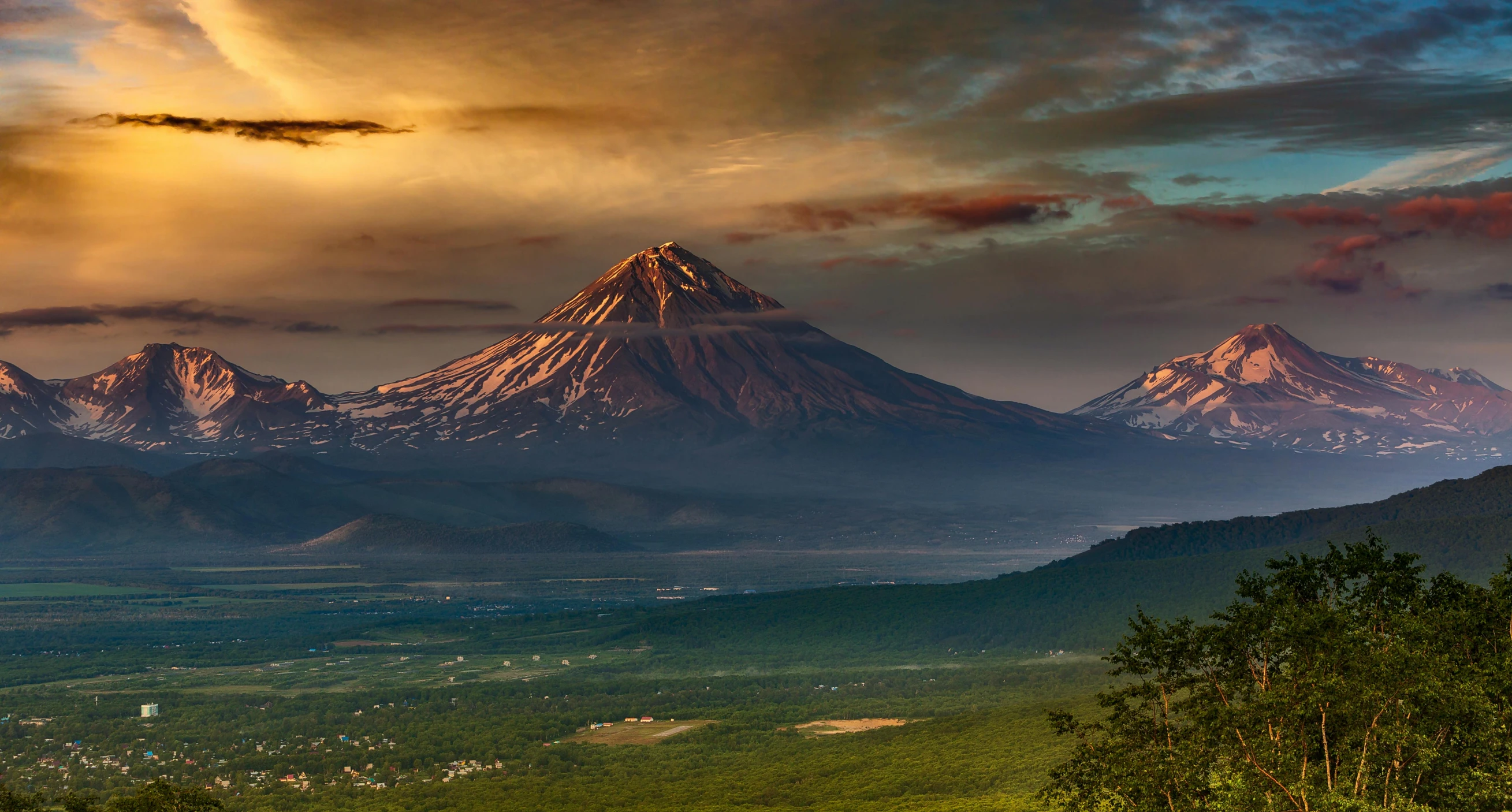 an aerial view of the mountains in the sun