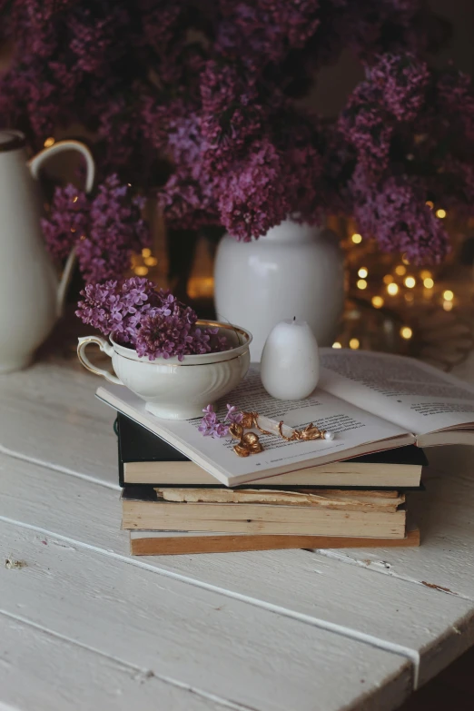 a few books, and some flowers sitting on a table