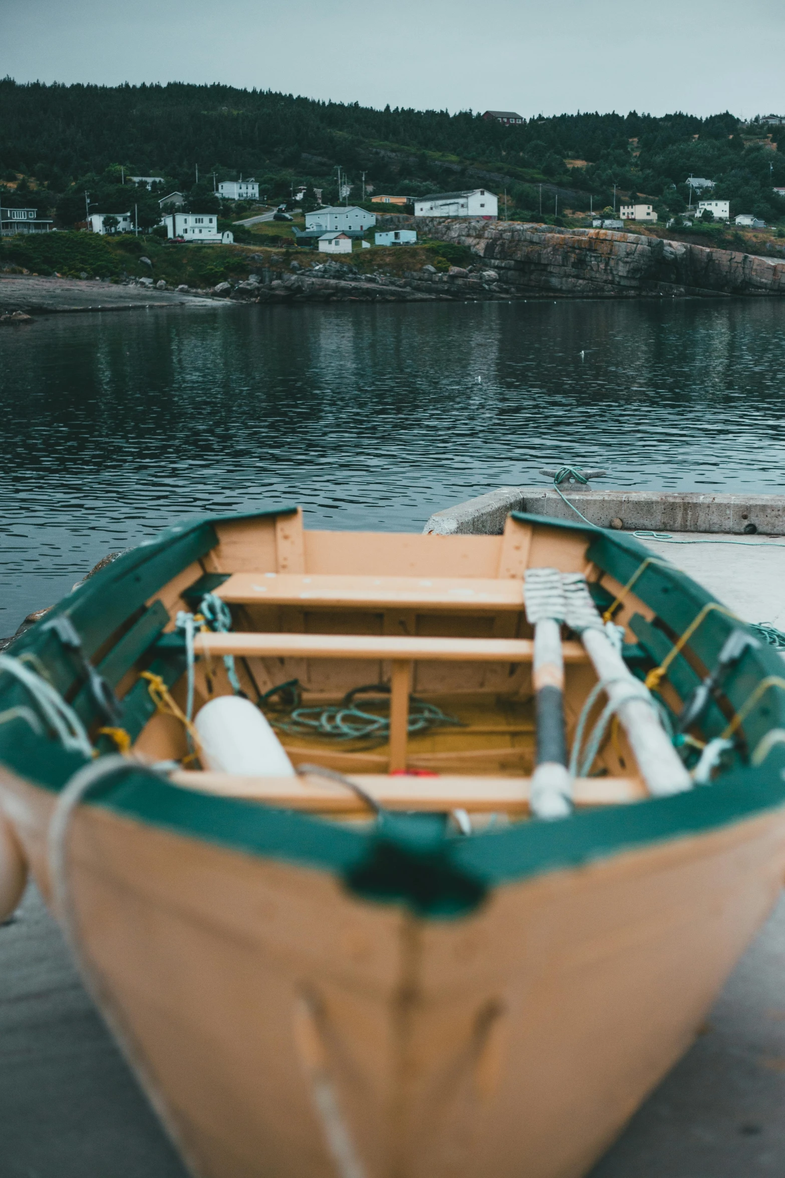 a boat sitting on top of a body of water, by Jessie Algie, unsplash, small port village, cinestill 800t eastmancolor, dingy gym, a wooden