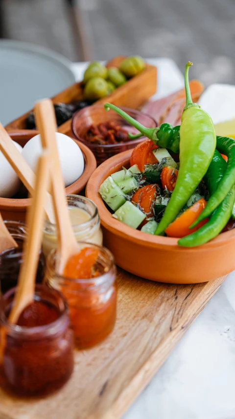 a wooden tray filled with different types of food, by Elizabeth Durack, pexels, square, pot, relish, fancy dressing