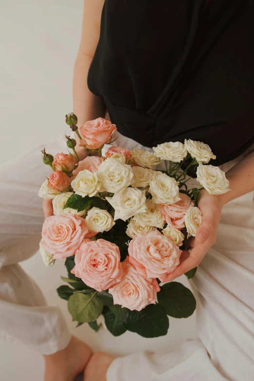 a person holding a large bunch of flowers in their hands