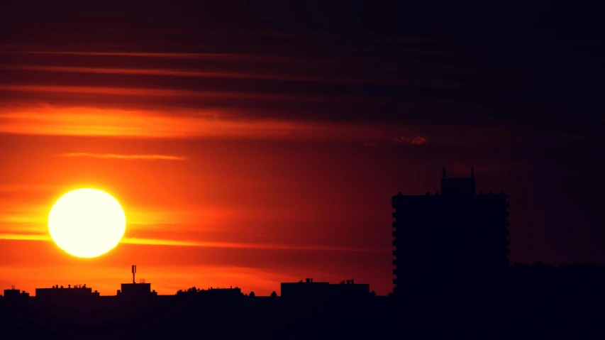 the sun is setting over the city skyline, a photo, by Attila Meszlenyi, realism, red sunset, digital photo, ..', silhouette :7