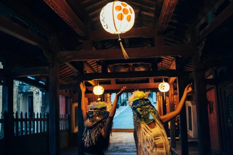 two girls in traditional japanese dress are holding torches