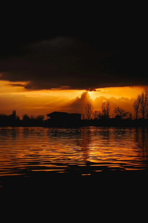 a cloudy sunset in the background and dark clouds