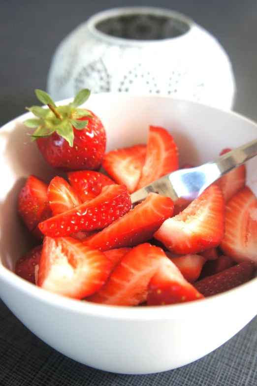 a bowl of strawberries with a fork in it, hurufiyya, crisp clean shapes, having a snack, cuts, shiny crisp finish