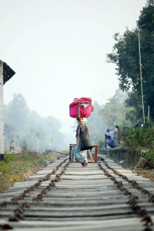 a woman walking down a train track with a pink umbrella, inspired by Steve McCurry, happening, single bangla farmer fighting, dragging a pile of chains, an ahoge stands up on her head, burnt