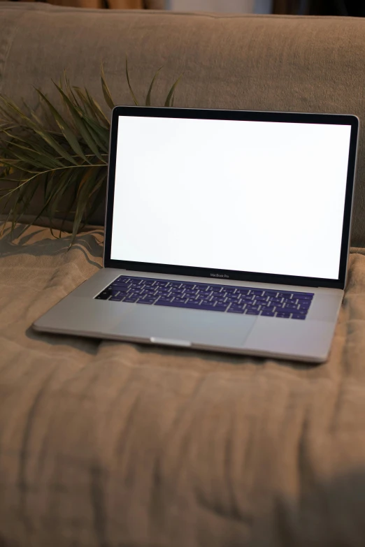 a laptop computer sitting on top of a couch, by Carey Morris, pexels, non-illuminated backdrop, beach setting, headshot, rectangle