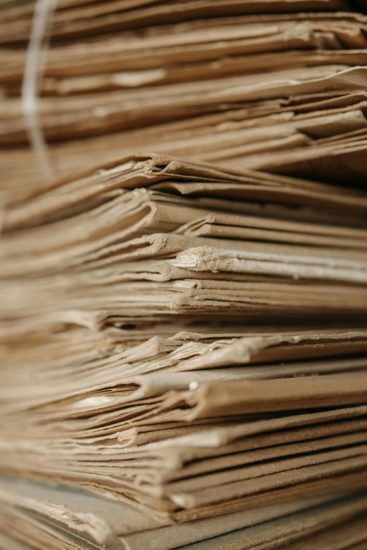 a stack of papers sitting on top of a table, an album cover, unsplash, renaissance, brown paper, multiple stories, close - ups, rustic