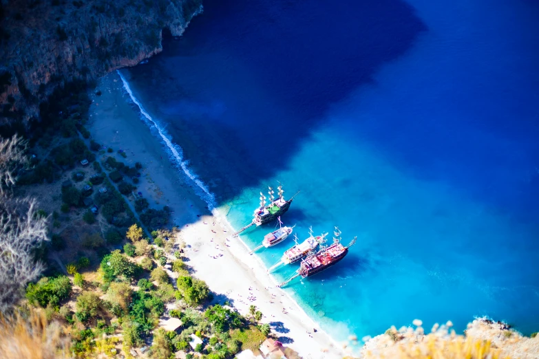 a group of boats sit in the clear water