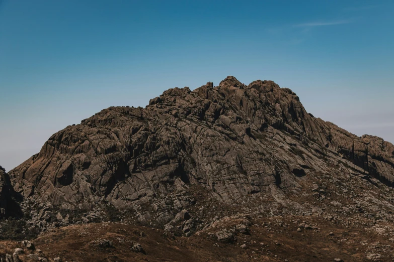 the top of a mountain with rocks in the foreground