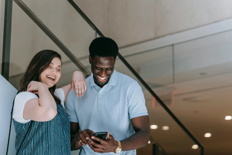 a man and a woman looking at a cell phone, pexels contest winner, smiling, avatar image, mkbhd, woman holding another woman