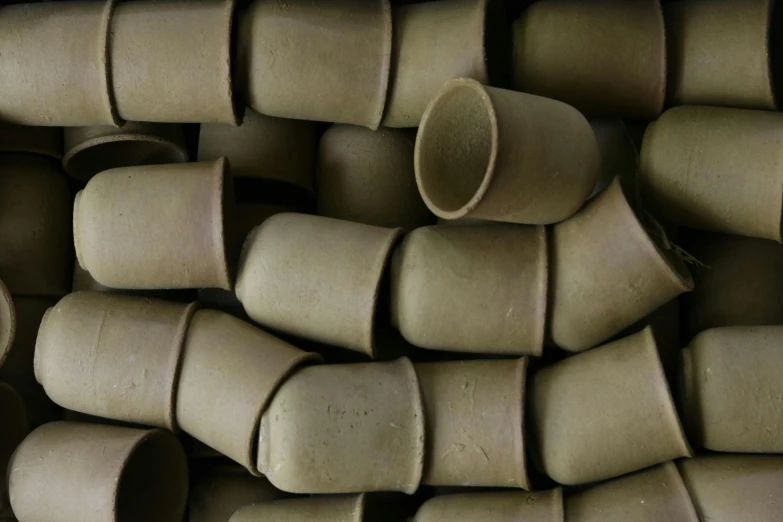 a pile of clay pots stacked on top of each other, inspired by Giorgio Morandi, unsplash, mingei, olive green, made of rubber, medium closeup, drinking