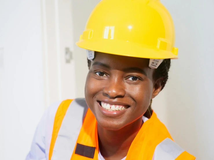 a close up of a person wearing a hard hat, inspired by Afewerk Tekle, male teenager, black teenage girl, professional image, health supporter