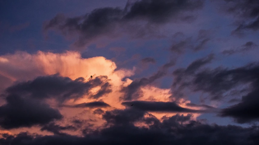 a red light shining on the clouds at night