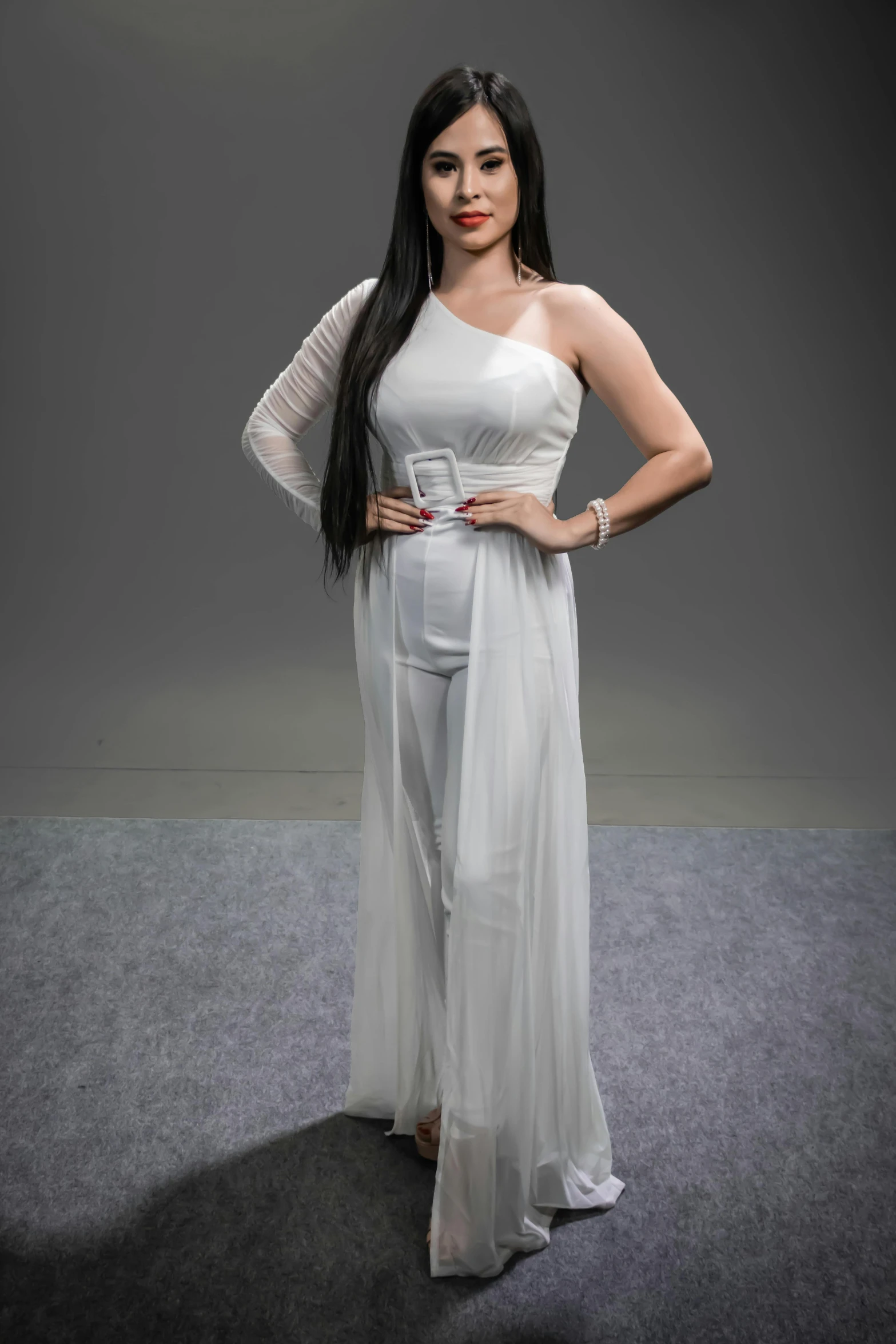 a woman in white dress and grey background