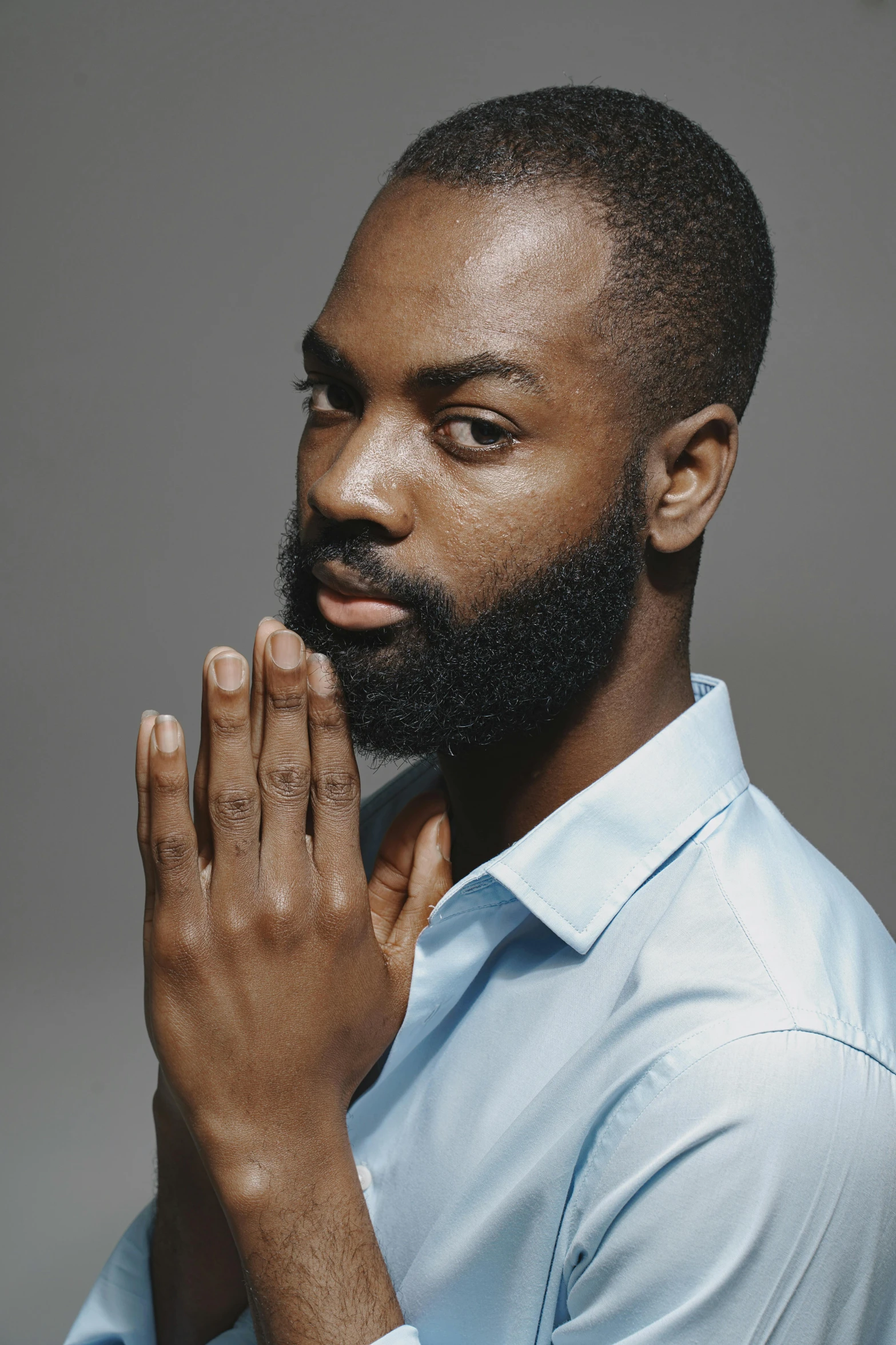 a man with a beard posing for a picture