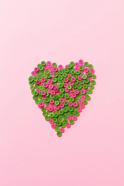 a pink and green heart on a pink background, inspired by Germán Londoño, pexels, made of flowers and berries, buttons, #green, spiralling