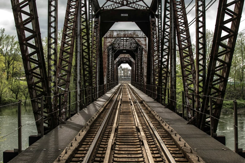 the train tracks are close together on the bridge