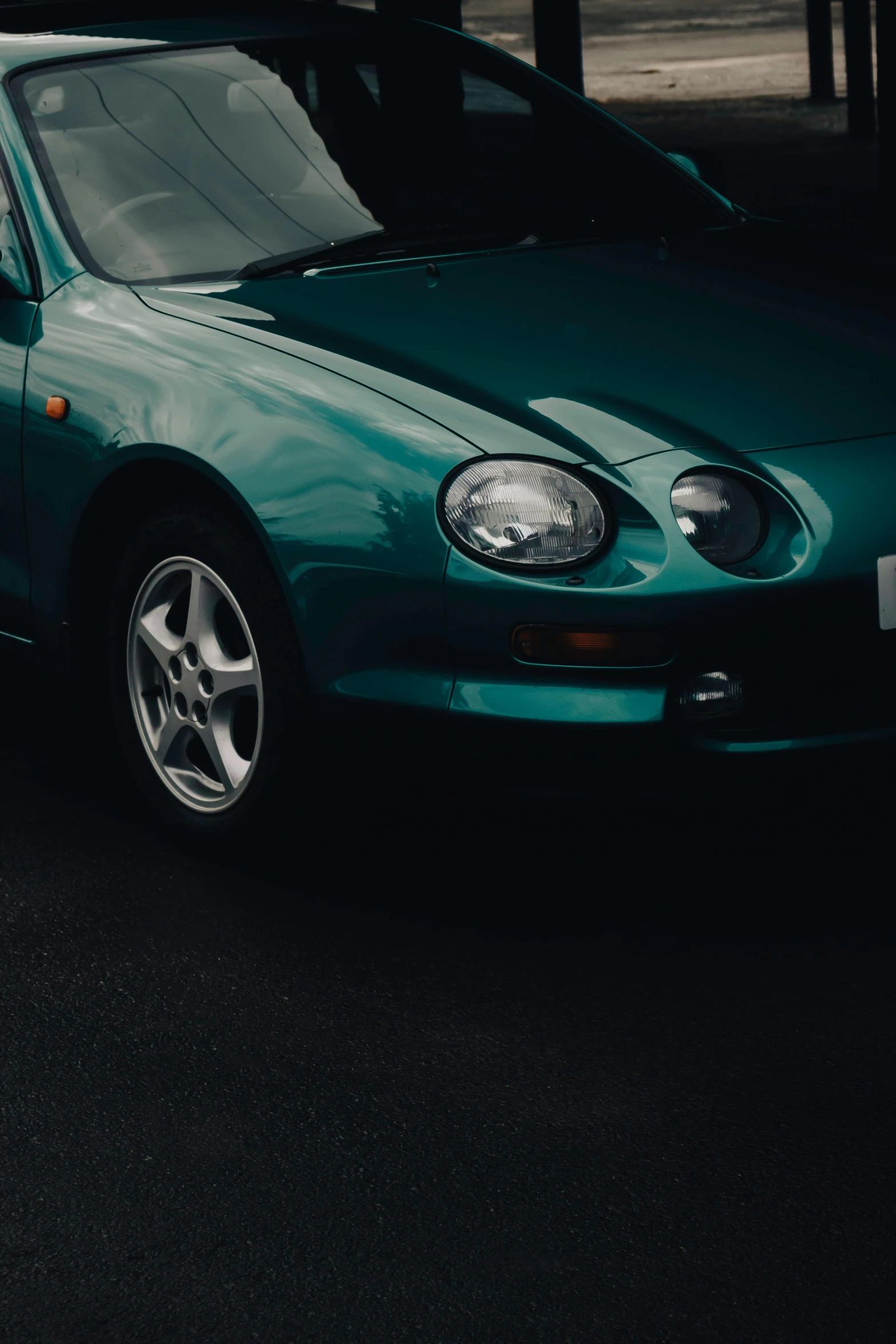 a green car parked in a parking lot