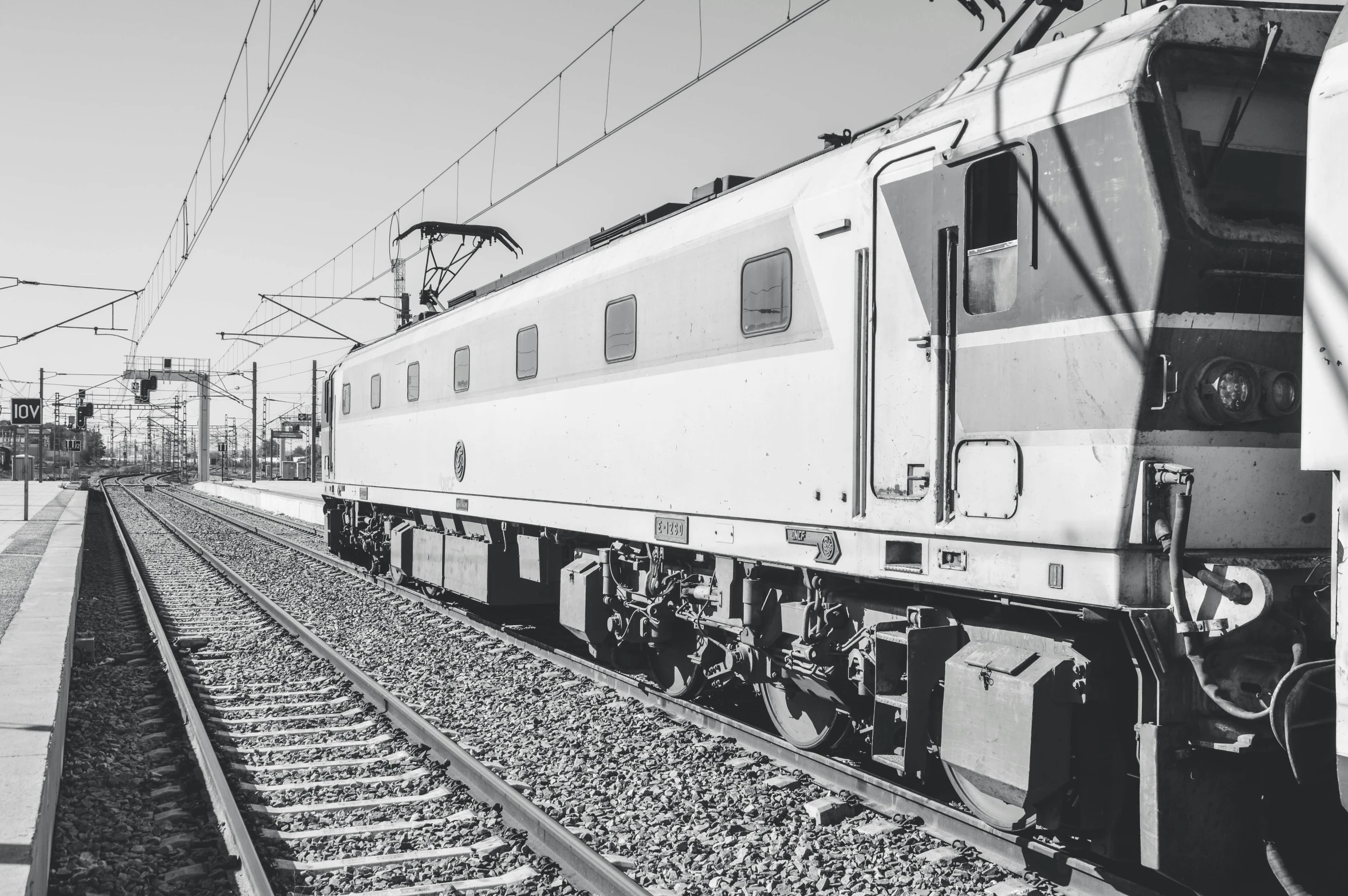 a black and white photo of a train on the tracks, a black and white photo, unsplash, instagram post, monochrome 3 d model, sunny day, 🚿🗝📝