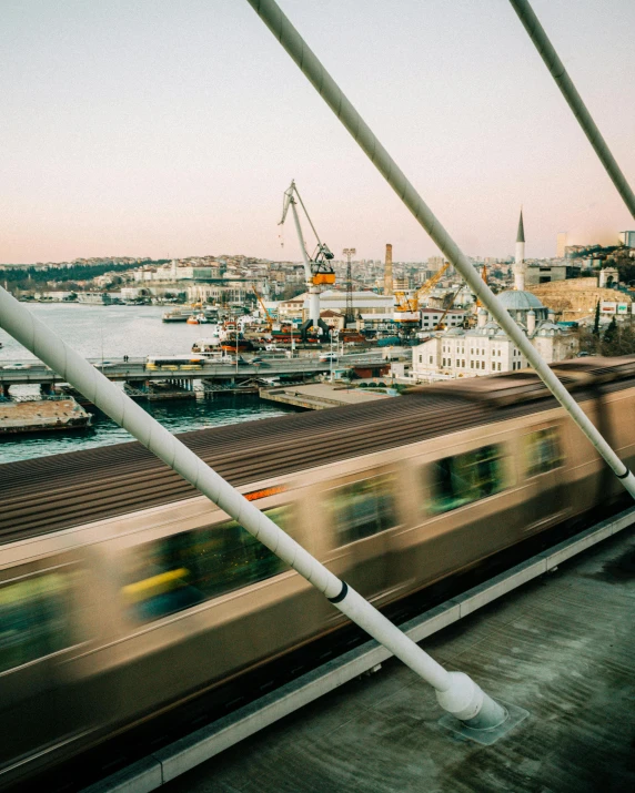 a view of a train speeding by with a large city in the background