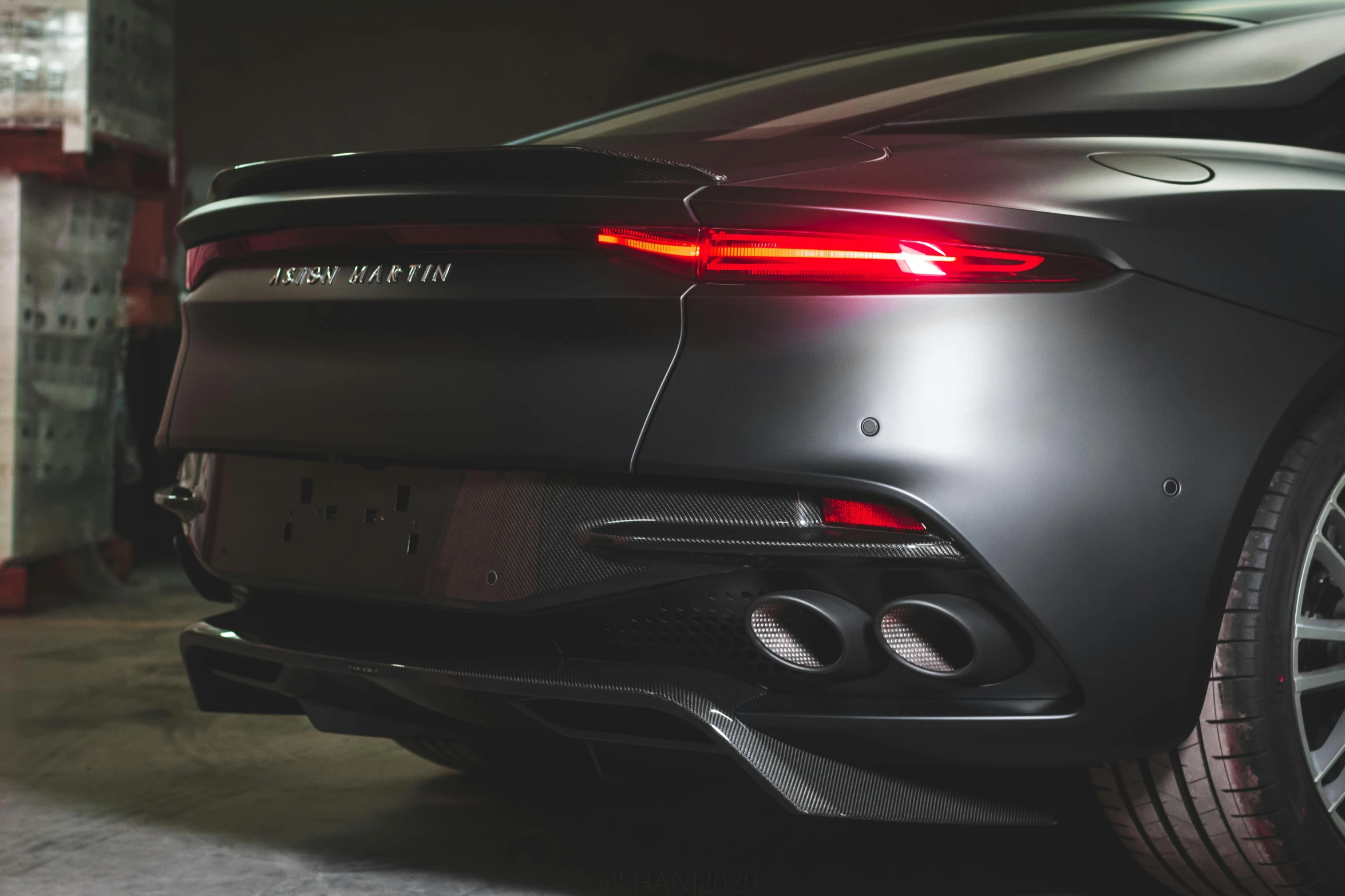 a grey sports car parked in a garage