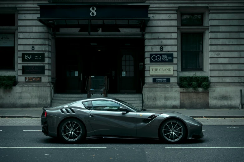 a car is parked on the street in front of a building