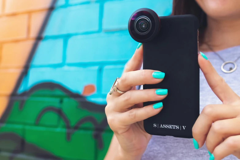 a close up of a person holding a cell phone, unsplash, photorealism, fisheye!!! lens, standout colours, axsens, instagram photo shoot