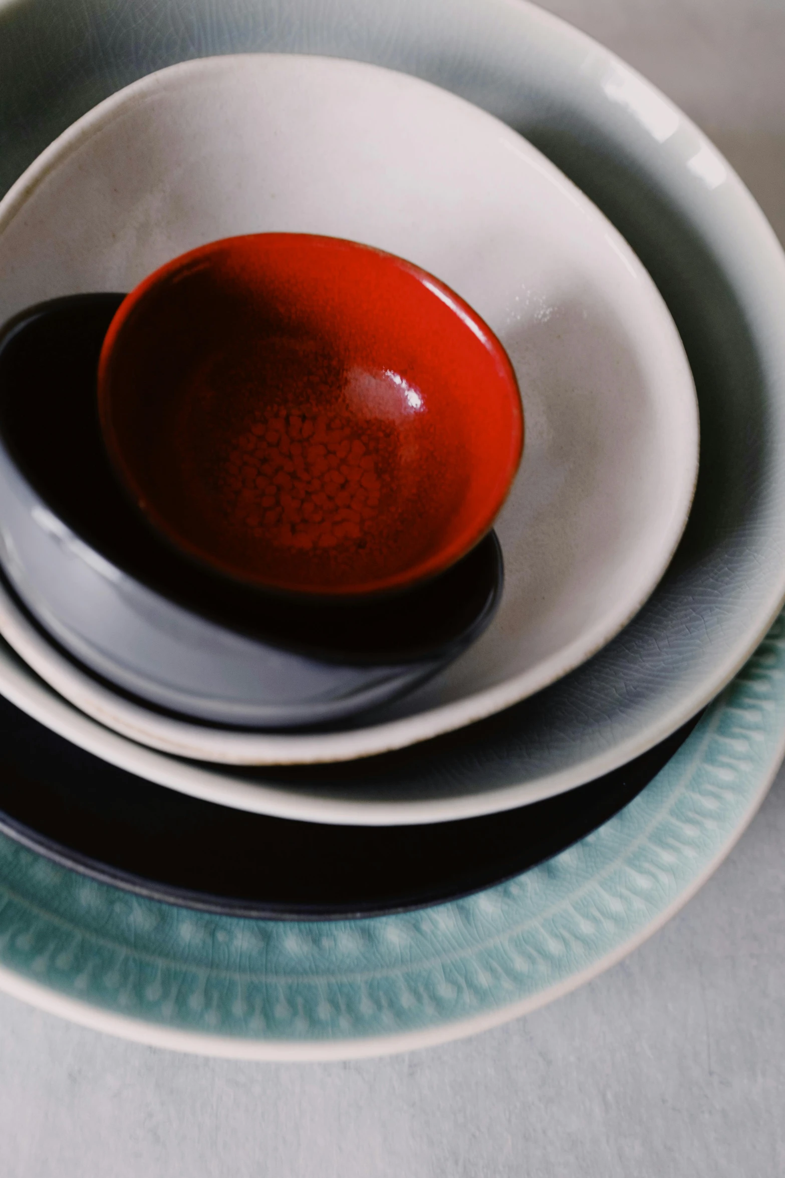 a stack of plates sitting on top of each other, a still life, by Doug Ohlson, unsplash, renaissance, red and grey only, made of glazed, bowl, high angle close up shot